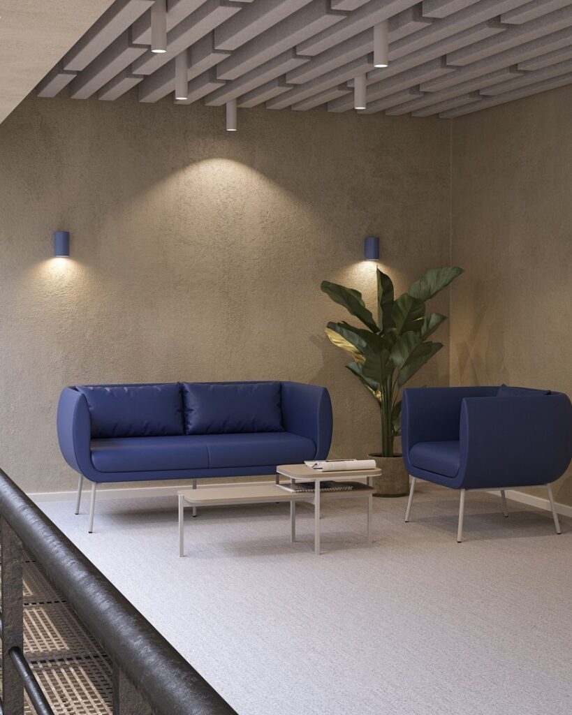 Dublex — Blue two-seater sofa and armchair set with a beige two-tier coffee table in a modern office lobby