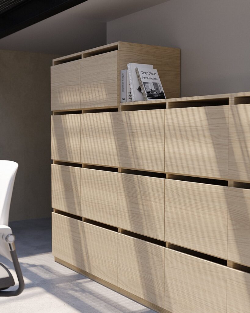 Layer Dolap — A light wood textured, multi-doored, modular cabinet with books on top and a white chair in an office setting