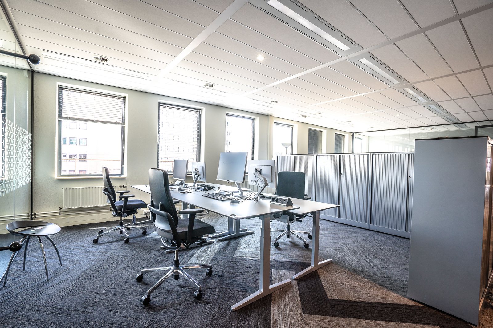 Bright and spacious modern office interior featuring sleek workstations and ergonomic chairs.