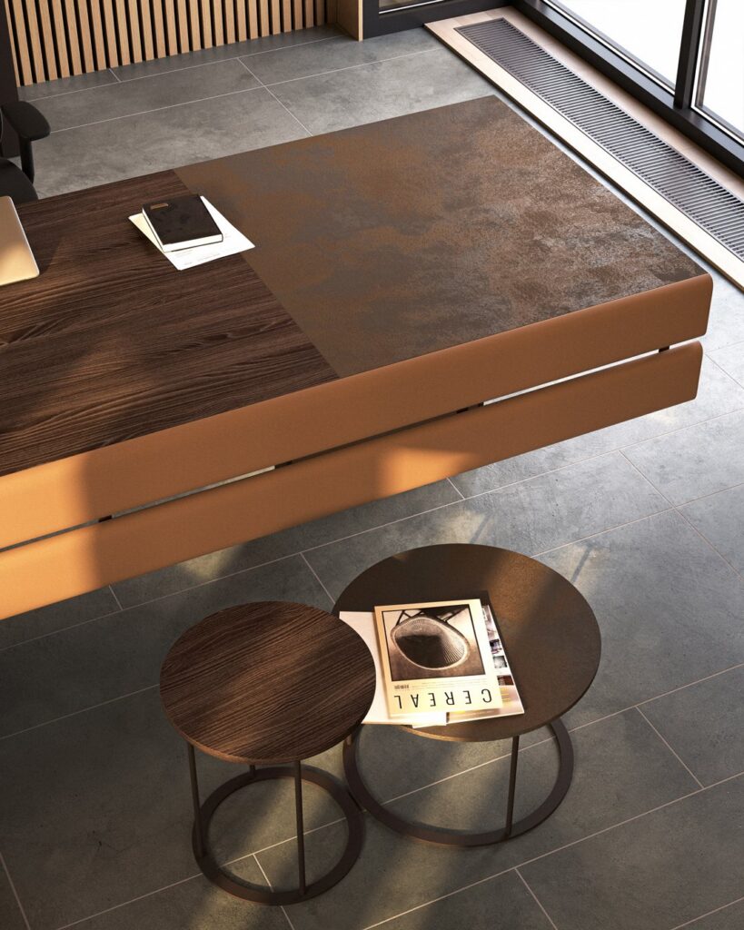 Plato — Executive desk with dark wood and rusty metal-look surface, with two round side tables in a modern office setting
